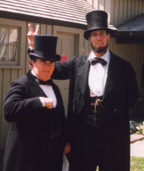Max, as President Lincoln, giving Kevin Griffin, as Senator Douglas, rabbit ears